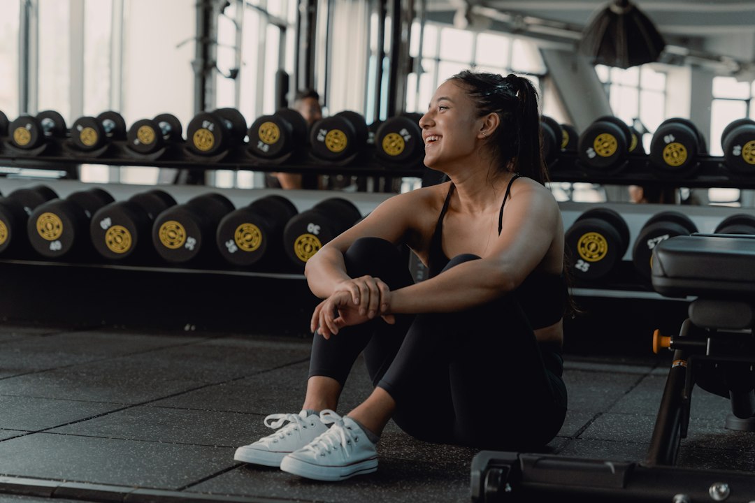 An athlete rests between sets in a weight room