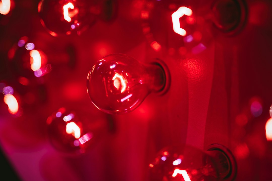 Red therapy bulbs glowing close together, a different light tool from a heated PEMF mat
