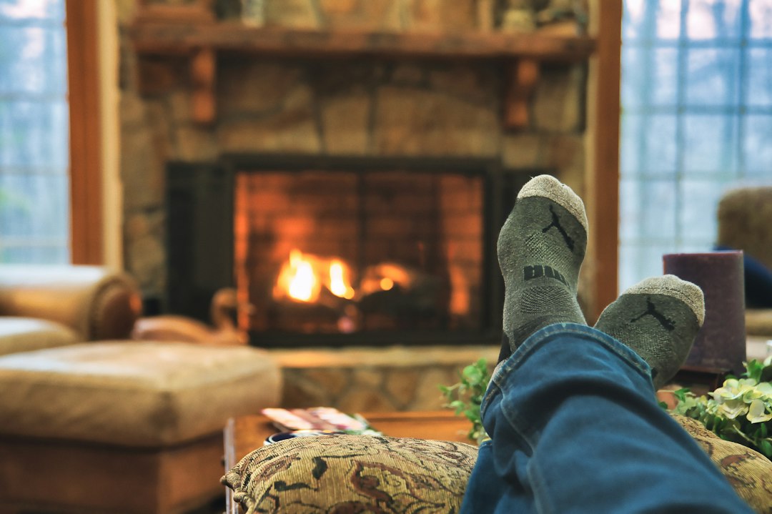 Feet in thick wool socks warming up on a couch