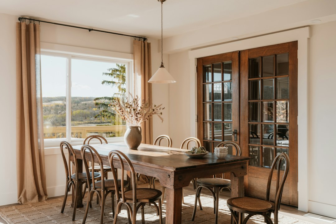 Sunlit dining table with autumn light through the window