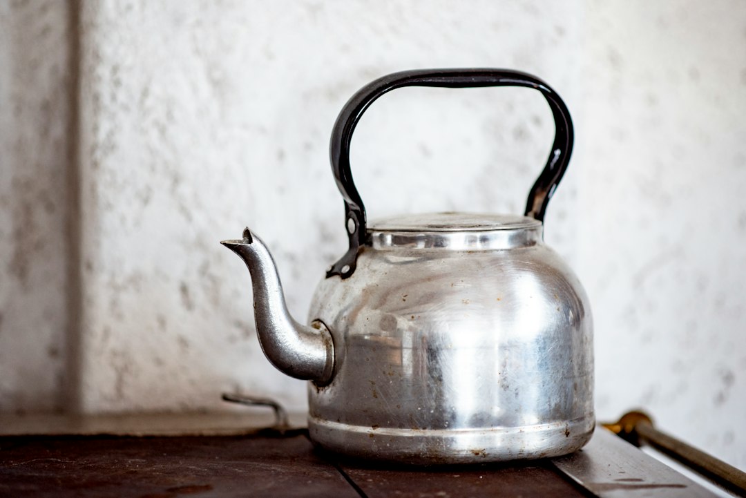 A classic stovetop kettle on a wooden surface