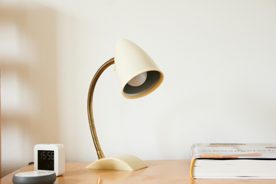 small desk lamp and clock on a minimal desk