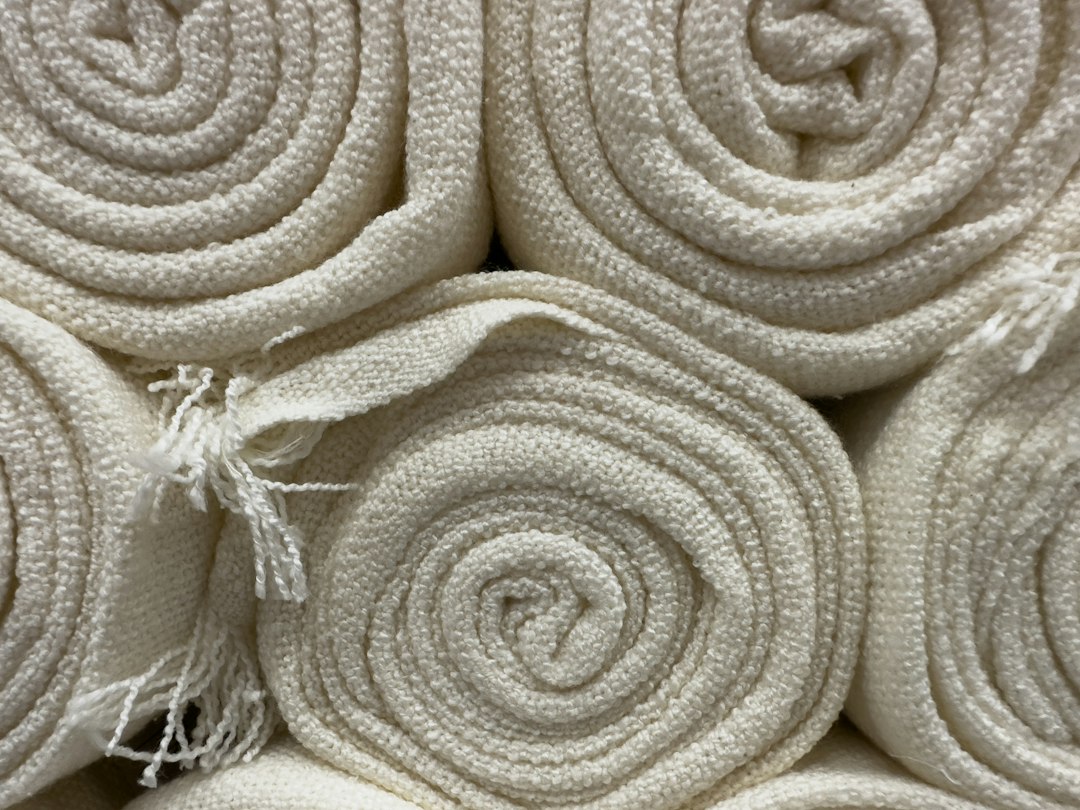 Rolled cotton towels, the thin layer that belongs between skin and a heated mat