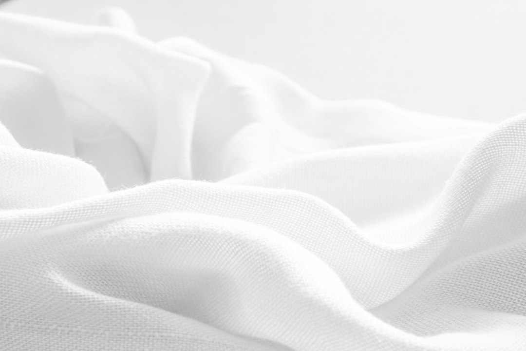 Close-up of crisp white breathable sheet fabric
