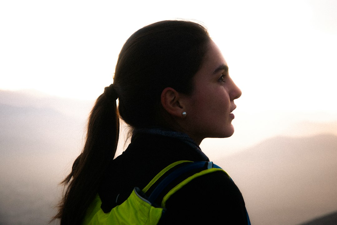 A runner in a reflective vest trains at misty dawn