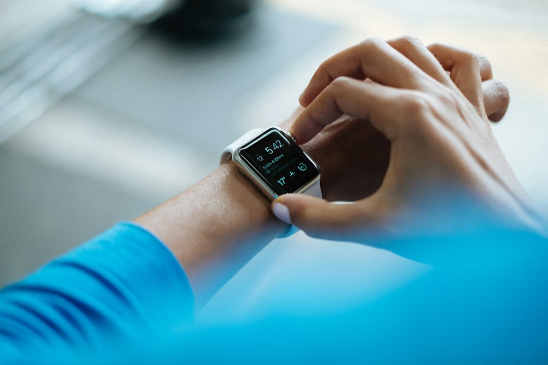 Hands interacting with a smartwatch display showing workout data after a training session