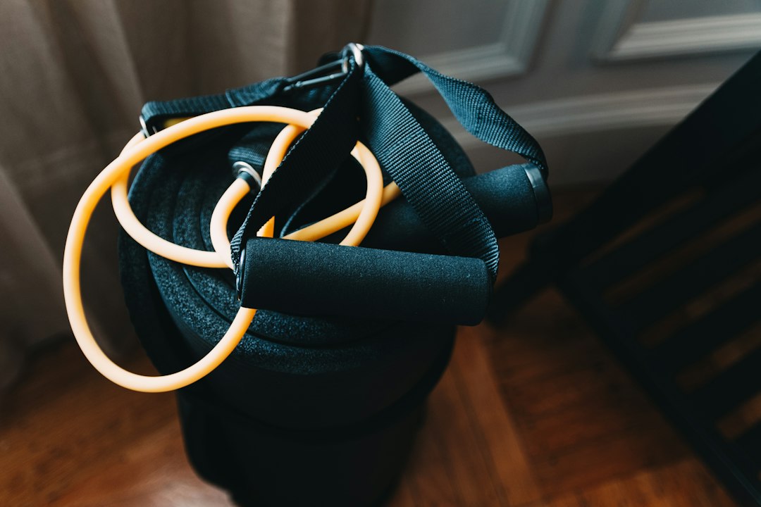 Resistance bands and handles resting on a rolled exercise mat