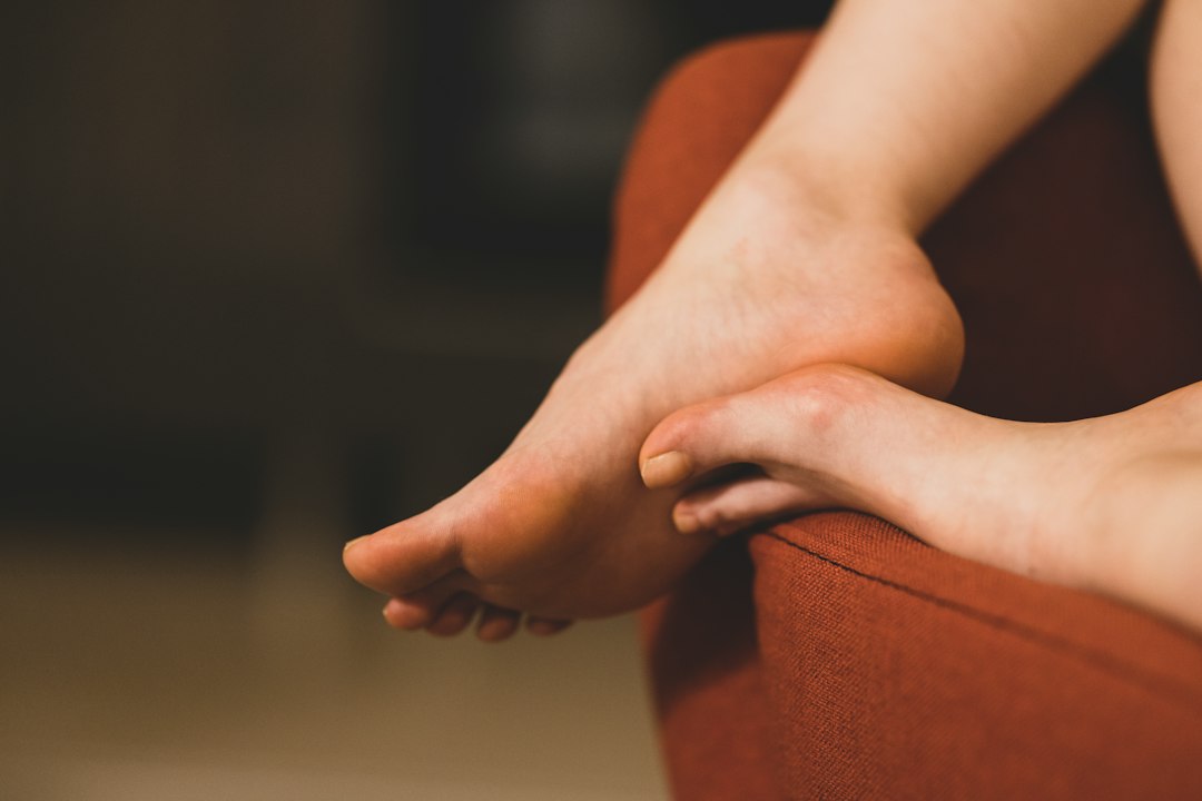 Bare feet resting crossed on a chair at home